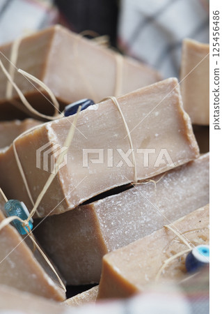Natural handmade soap displayed in a market during daytime Natural handmade soap displayed in a market during daytime 125456486