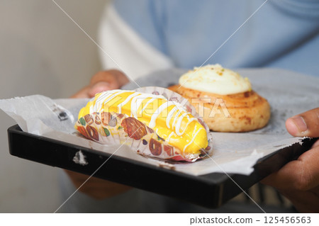 Delicious pastries served on a tray at a bakery Delicious pastries served on a tray at a bakery 125456563