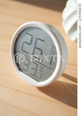 Digital thermometer shows temp and humidity on wood 125456878