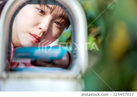 Woman taking out mail 125457017