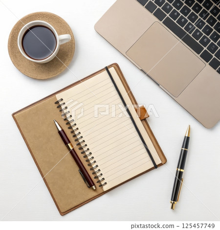 A workspace with a laptop notebook and coffee mug long title A well organized and minimalist A workspace with a laptop notebook and coffee mug long title A well organized and minimalist 125457749