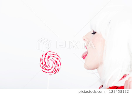 Woman with white wig and lollipop Woman with white wig and lollipop 125458122