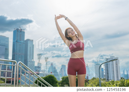 Young beautiful woman sportswear workout clothes exercise in street city park before morning run. Asian strong female sporty sportswear stretching outdoors. fitness healthy concept. Young beautiful woman sportswear workout clothes exercise in street city park before morning run. Asian strong female sporty sportswear stretching outdoors. fitness healthy concept. 125458196