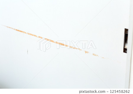 Scratches on wooden sliding door 125458262