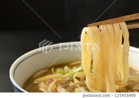 Picking up curry udon noodles made from leftover curry with chopsticks 125458400