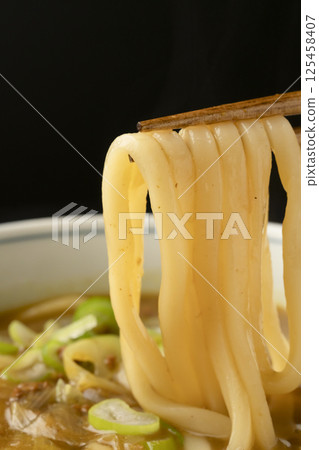 Picking up curry udon noodles made from leftover curry with chopsticks 125458407
