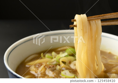 Picking up curry udon noodles made from leftover curry with chopsticks 125458410