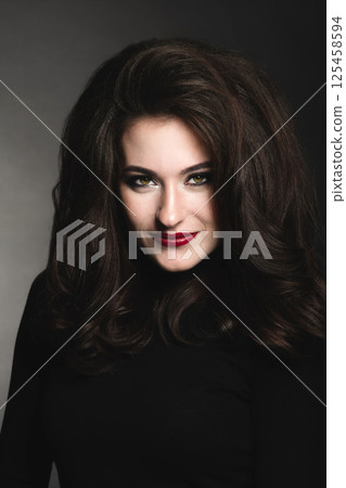 Beautiful woman with long dark hair studio portrait Beautiful woman with long dark hair studio portrait 125458594