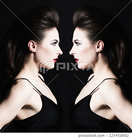 Beautiful woman with long dark hair studio portrait with reflection 125458602