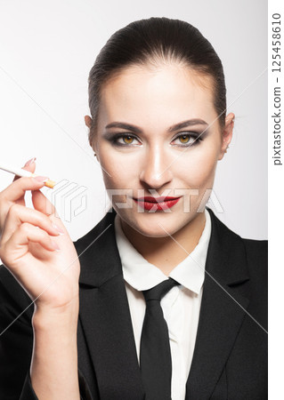 Woman portrait with black suit and cigarette Woman portrait with black suit and cigarette 125458610
