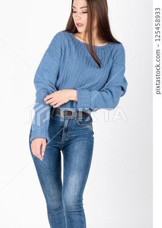Woman with jeans and sweater studio portrait Woman with jeans and sweater studio portrait 125458933
