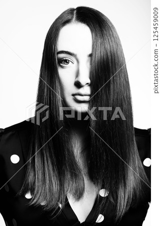 Beautiful woman with long dark hair studio portrait Beautiful woman with long dark hair studio portrait 125459009