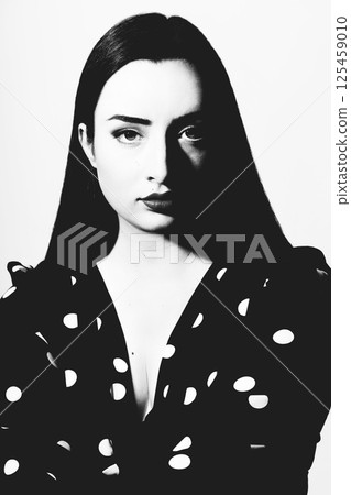 Beautiful woman with long dark hair black and white studio portrait Beautiful woman with long dark hair black and white studio portrait 125459010