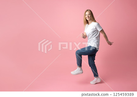 Happy Woman Posing on Pink Background 125459389