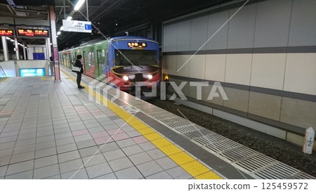 A train stopping at a platform at night A train stopping at a platform at night 125459572