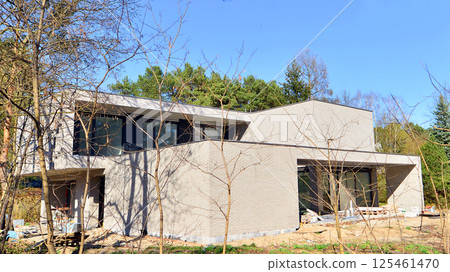 A suburban district of single-family homes. Single family house construction site. Modern designed single-family house under construction. 125461470