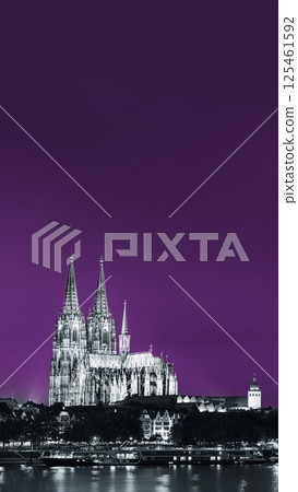 Cologne, Germany. Night View Of Cologne Cathedral. Catholic Gothic Cathedral In Night. UNESCO World Heritage Site. Toned Photo Black, White And Ultra Violet Colors Cologne, Germany. Night View Of Cologne Cathedral. Catholic Gothic Cathedral In Night. UNESCO World Heritage Site. Toned Photo Black, White And Ultra Violet Colors 125461592