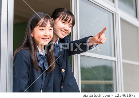 Junior and senior high school girls cheering from the classroom windows Junior and senior high school girls cheering from the classroom windows 125461672