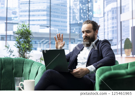 Successful male entrepreneur meeting online with his experts team, focusing on problem solving, decision making and achieving strategic objectives. Productivity for a success story. Successful male entrepreneur meeting online with his experts team, focusing on problem solving, decision making and achieving strategic objectives. Productivity for a success story. 125461965