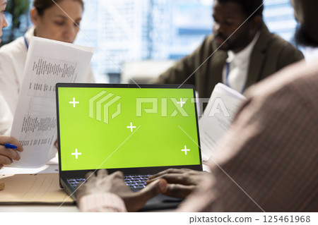 Business associates in a meeting using isolated chroma key display, working on resource allocation plans to increase profit. Team of corporate employees in a project briefing. Close up. Business associates in a meeting using isolated chroma key display, working on resource allocation plans to increase profit. Team of corporate employees in a project briefing. Close up. 125461968
