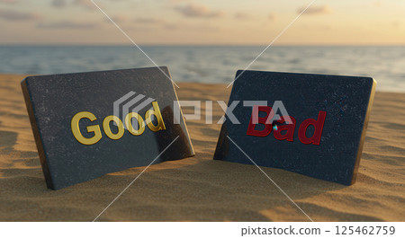 Two polished stone tablets rest on a sandy beach, each etched with a contrasting message. The left tablet displays the word Good in shimmering gold, while the right says Bad in red. 125462759