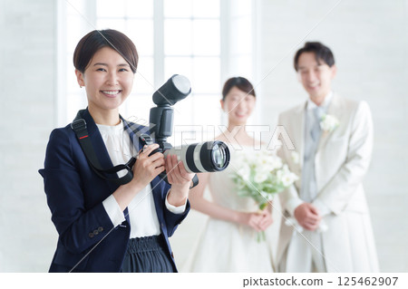 Bridal photographer taking photos at a wedding 125462907