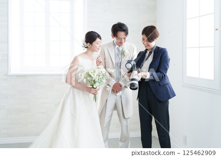 Bridal photographer taking photos at a wedding 125462909