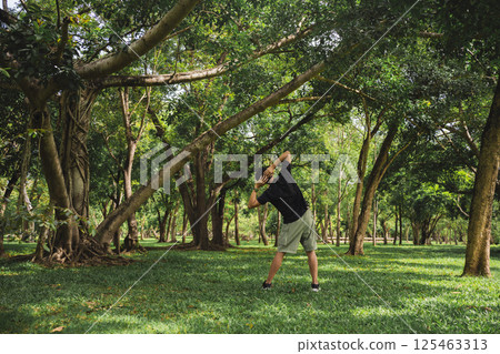 wellness concept with asian man exercise with tree in park on summer season 125463313