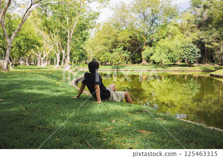 wellness concept with asian man exercise with tree in park on summer season 125463315