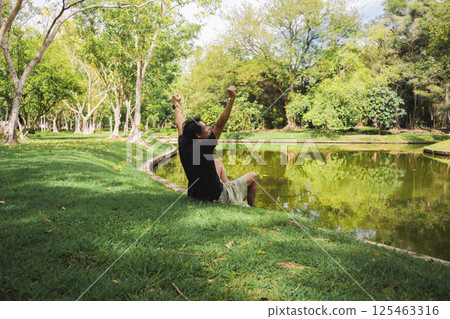 wellness concept with asian man exercise with tree in park on summer season 125463316