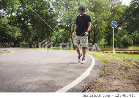 wellness concept with asian man exercise with tree in park on summer season 125463415