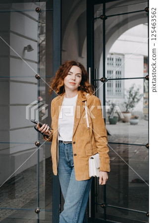 Young traveler embracing slow urban exploration on a peaceful city street. Mindful tourism, local culture, and relaxed digital lifestyle... 125463562