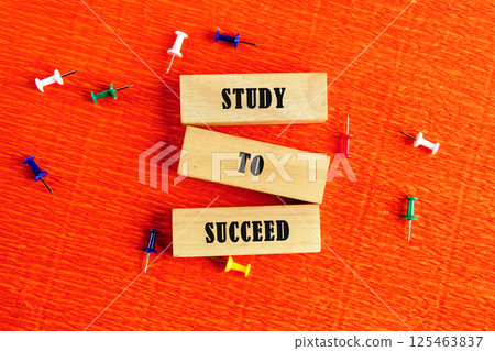 Encouraging Educational Message Highlighting Study to Succeed on a Vibrant Orange Background With Colorful Push Pins Encouraging Educational Message Highlighting Study to Succeed on a Vibrant Orange Background With Colorful Push Pins 125463837
