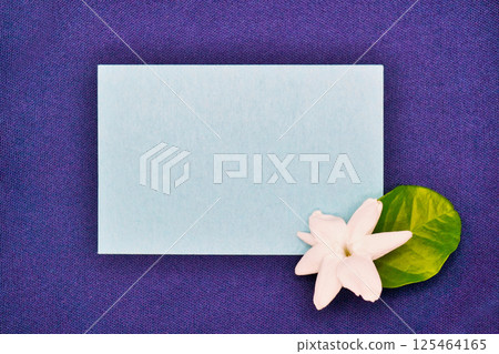 Mockup with jasmine flowers and simple message space on a dark blue background Mockup with jasmine flowers and simple message space on a dark blue background 125464165