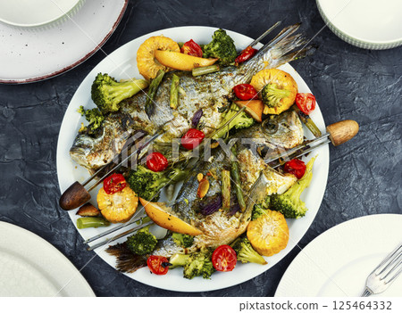 Roasted dorada fish with vegetables. 125464332
