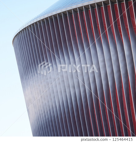 Cladding of a modern sports stadium against a blue sky Cladding of a modern sports stadium against a blue sky 125464415