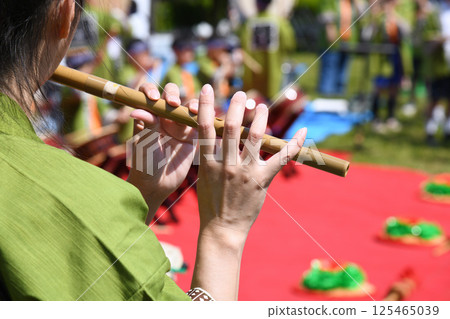 A woman playing a flute A woman playing a flute 125465039