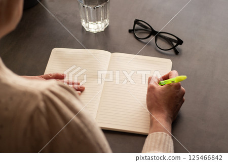Close up image of woman writing something in personal diary. Psychological concept. Putting all thoughts on paper. 125466842