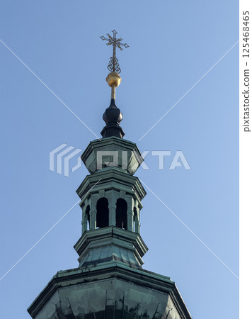 crucifix stands tall on the bell tower of a church crucifix stands tall on the bell tower of a church 125468465