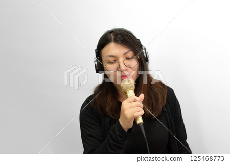 Woman (LGBTQ) singer sing a song with microphone 125468773