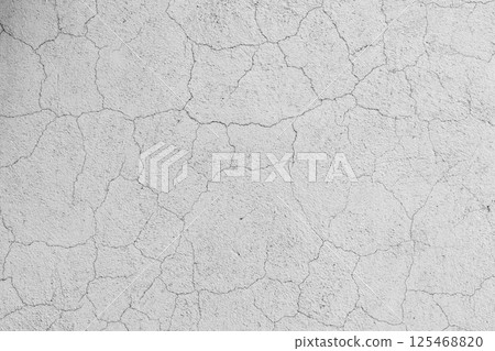 Abstract pattern of cracks on a white concrete wall surface, background Abstract pattern of cracks on a white concrete wall surface, background 125468820