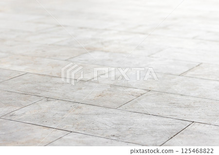 Tiled floor surface with a geometric layout, background photo Tiled floor surface with a geometric layout, background photo 125468822
