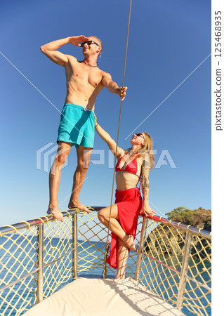 Couple enjoying sea adventure on yacht deck 125468935