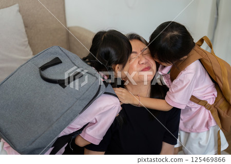 Love and School Excitement. Children hugging their caregiver after packing for school. 125469866
