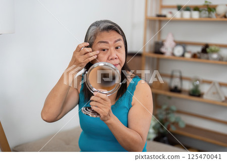Wellness approach for elderly woman caring for her appearance 125470041