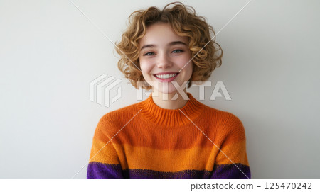 Smiling Woman in Colorful Sweater Against White Background 125470242