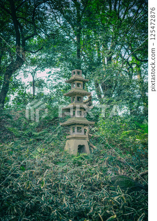 Stone lantern on the grass in the park Stone lantern on the grass in the park 125472876