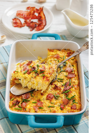 fresh corn pudding casserole in a baking dish fresh corn pudding casserole in a baking dish 125473286