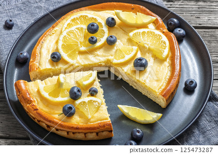 Cheesecake with blueberries sliced on a plate 125473287