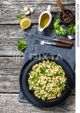 Pasta with green peas in a bowl, italian cuisine Pasta with green peas in a bowl, italian cuisine 125473294